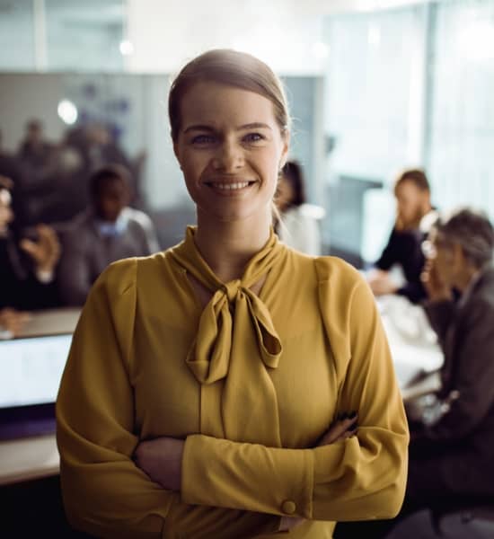 Professionally dressed woman standing in an office